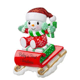 Personalized snowbaby on sled ornament, perfect for commemorating a special first Christmas memory.